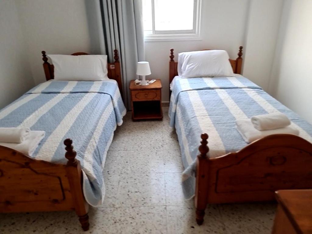 Postel nebo postele na pokoji v ubytování Latchi Area Apartments