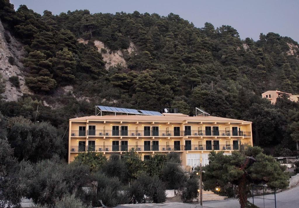 a building in front of a mountain at Glyfada Beach Hotel in Glyfada