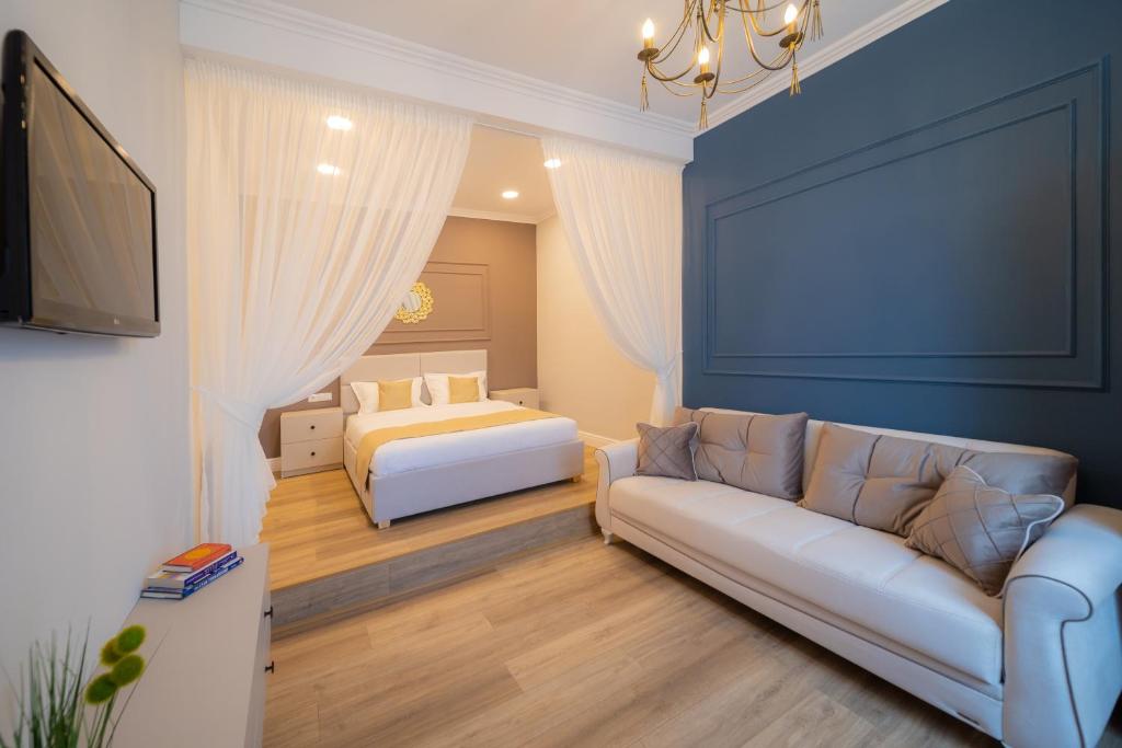 a living room with a bed and a couch at BlueSky Ultra-Central Premium Apartment in Oradea