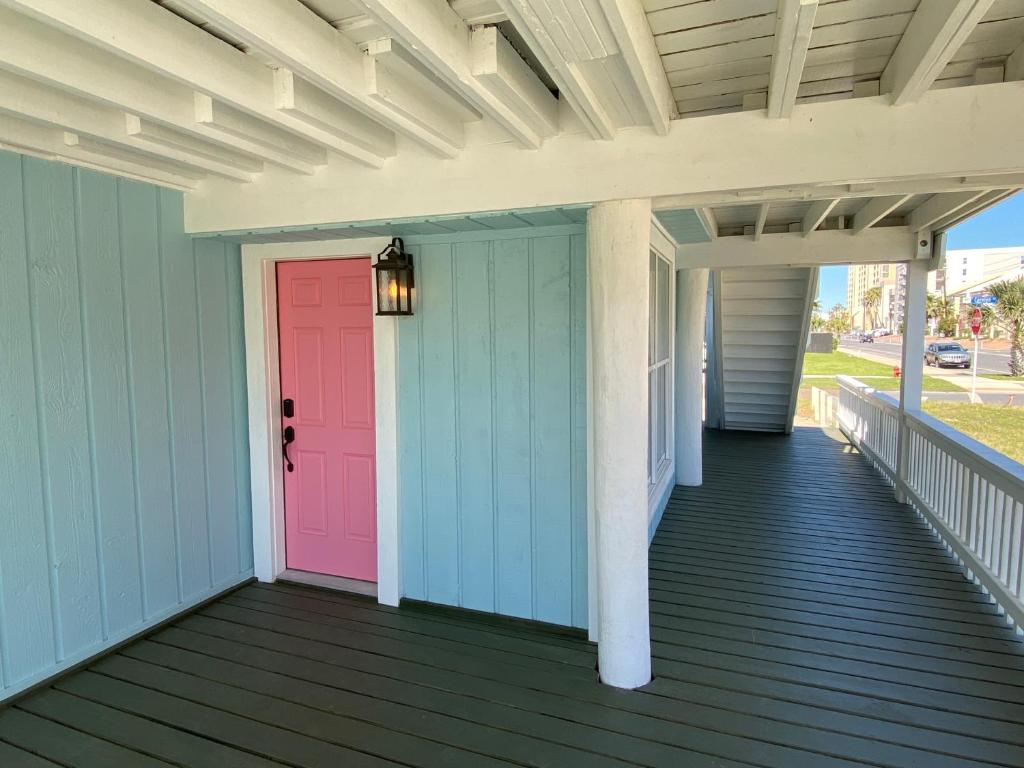 a colorful front porch with a pink door at South Padre Island Beach House Retreat Downstairs in South Padre Island