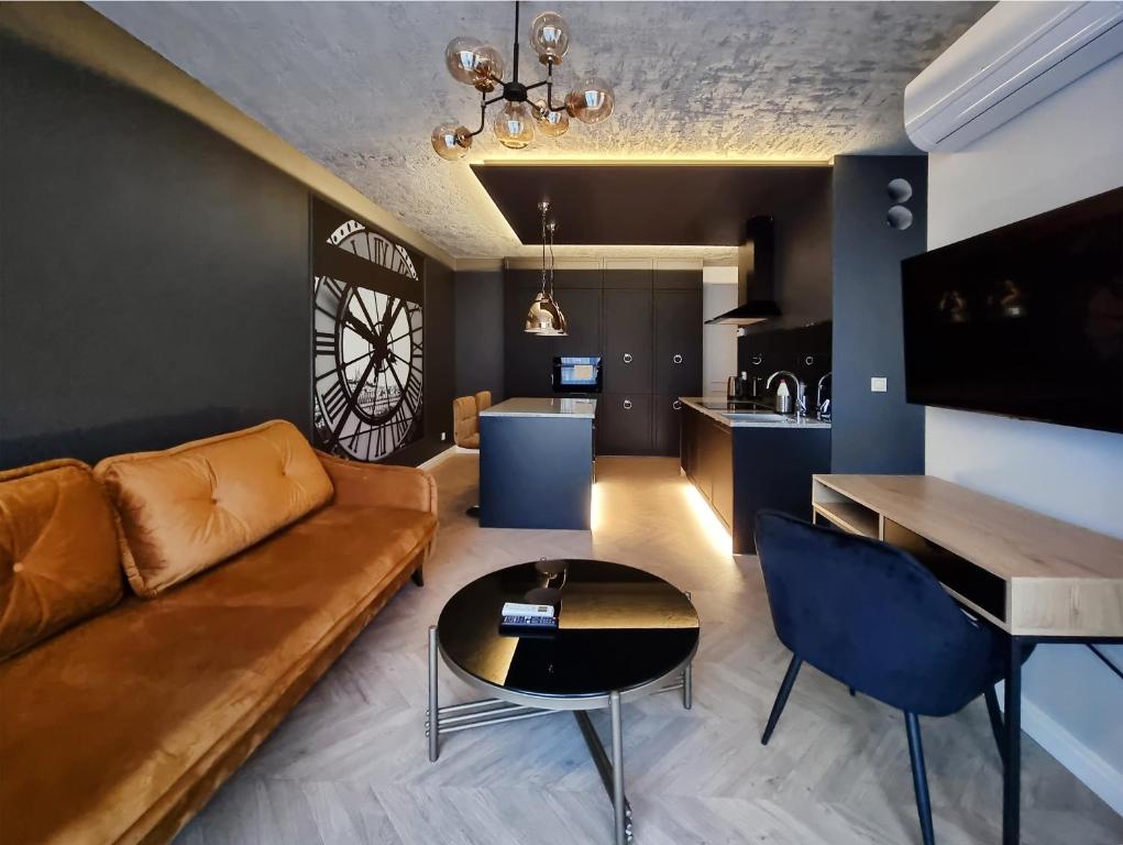 uma sala de estar com um sofá e uma mesa em Silesia Aparthotel em Szczecin