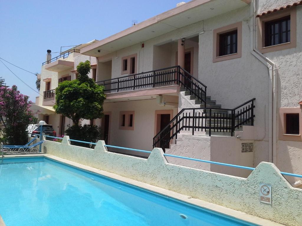 a villa with a swimming pool in front of a house at Amaril in Platanes