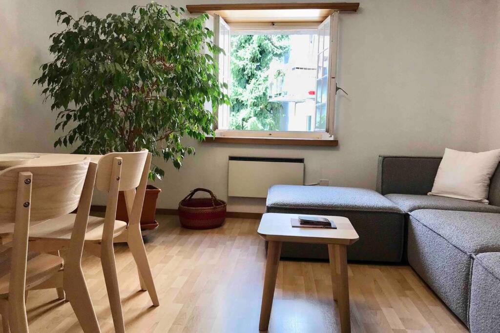 a living room with a couch and a table at Centrally Located Apartment in Poschiavo in Poschiavo