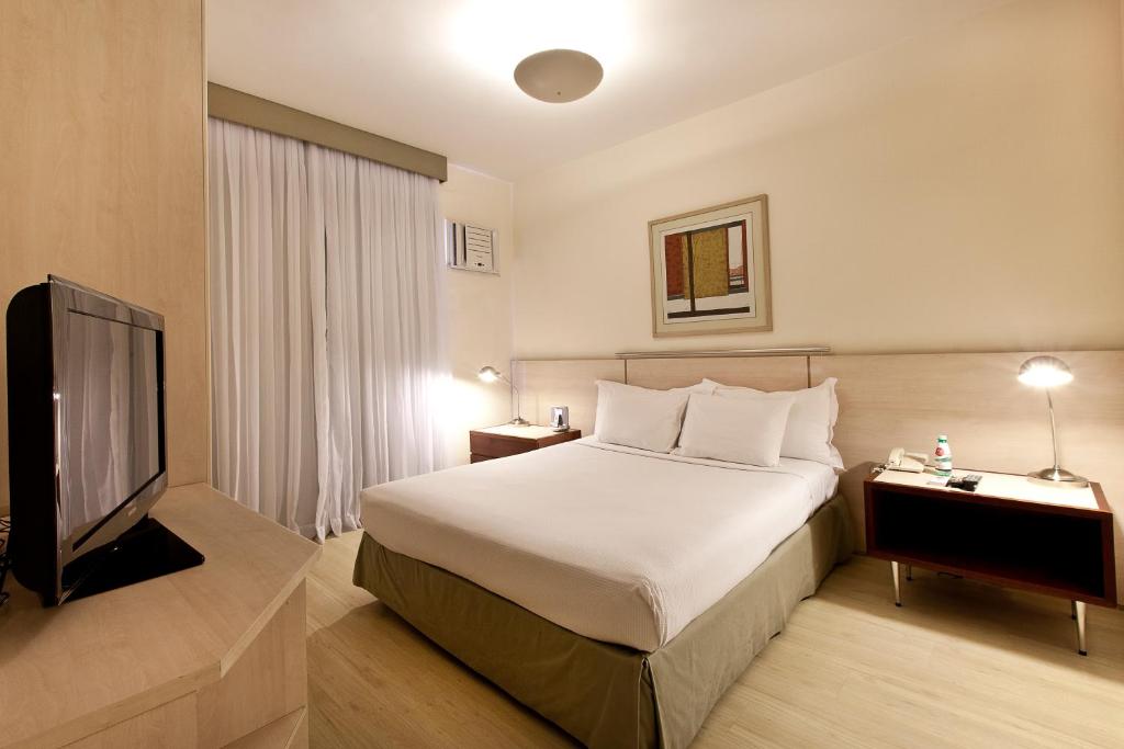 Llit o llits en una habitació de Promenade Pancetti Belo Horizonte