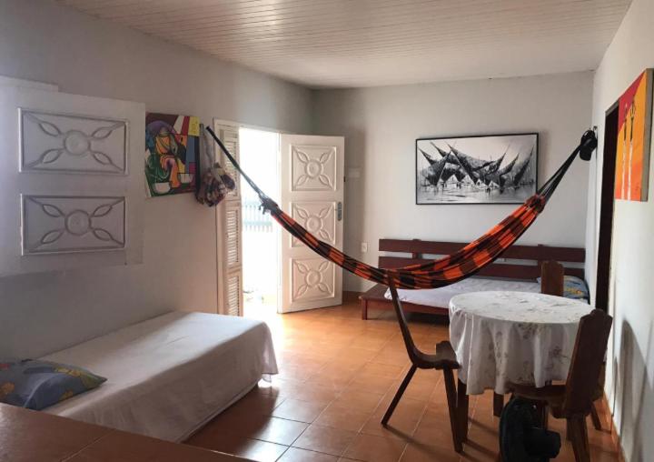 
a bed sitting in a room next to a wall at Casa Jeri in Jericoacoara
