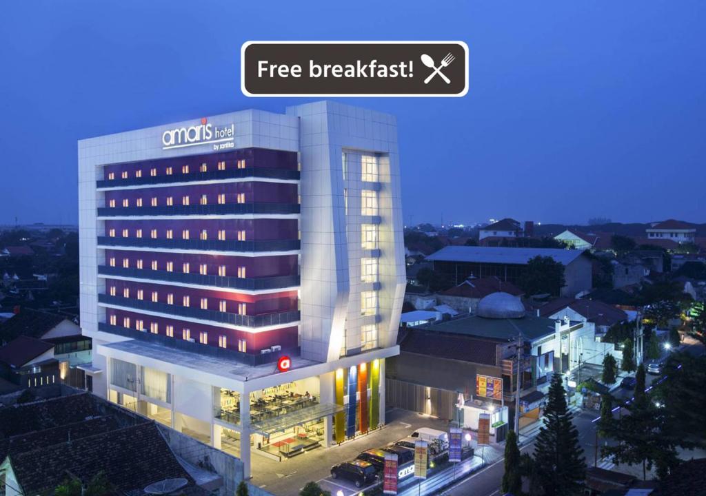 a rendering of a hotel with a free breakfast sign on it at Amaris Hotel Madiun in Madiun