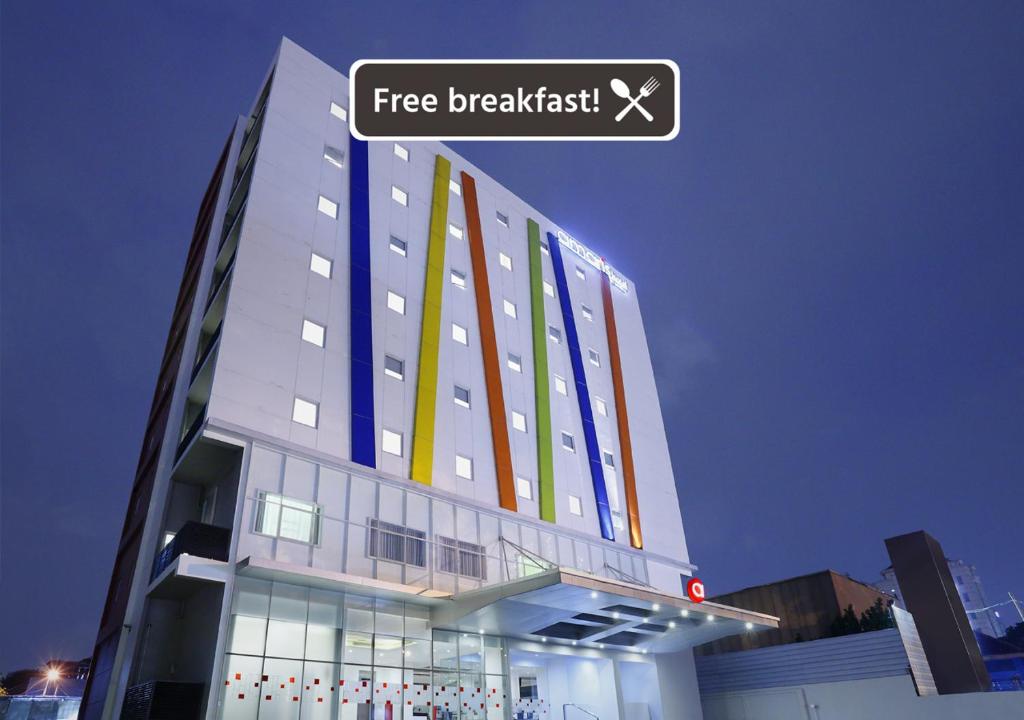 a building with a sign that reads free breakfast at Amaris Hotel Tebet in Jakarta
