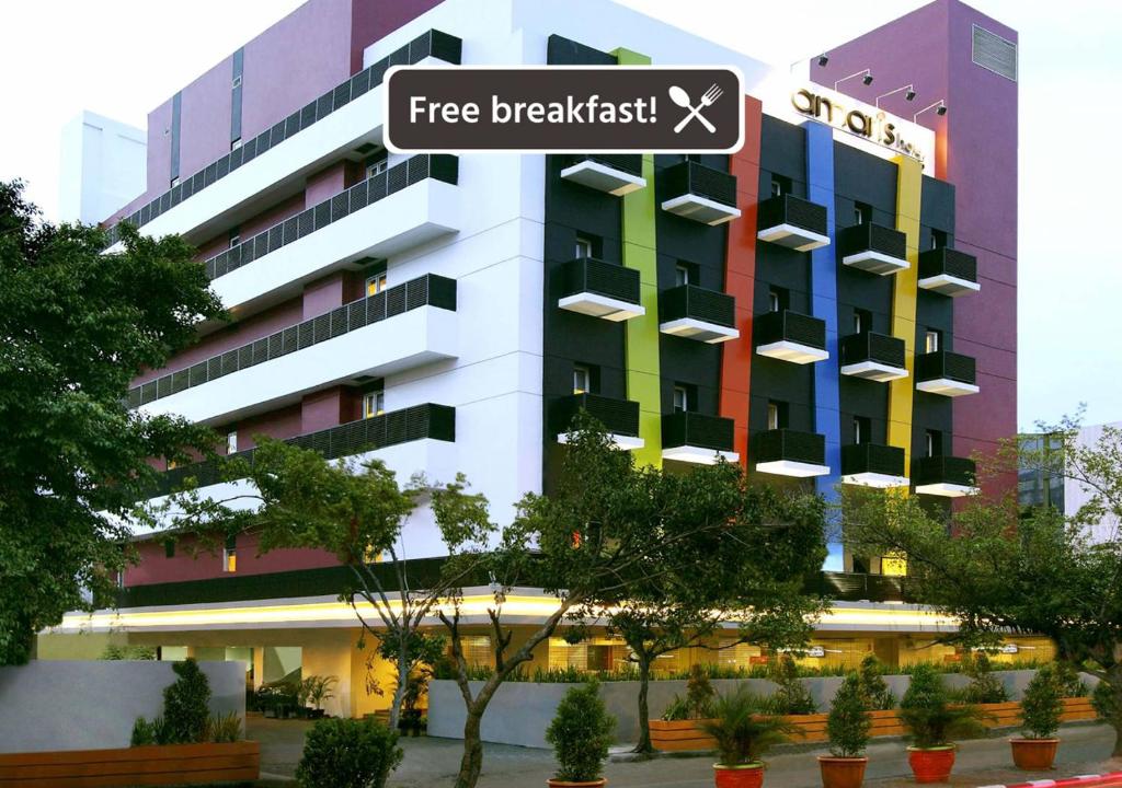 a building with a sign that reads free breakfast at Amaris Hotel Mangga Besar in Jakarta