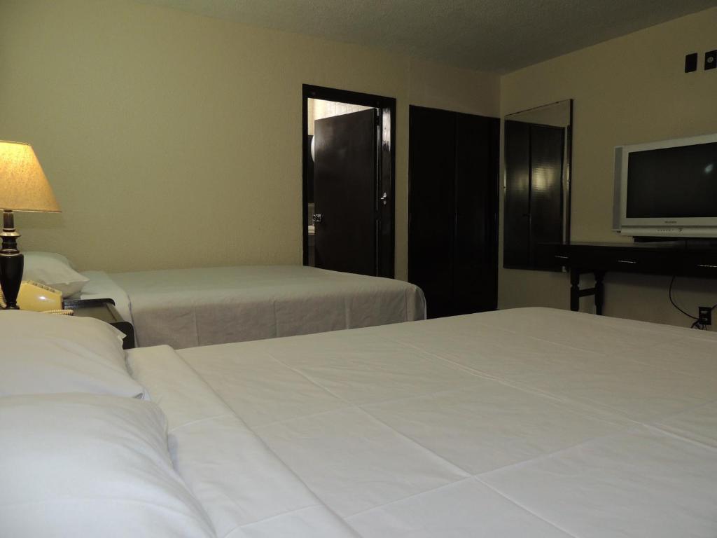 Postel nebo postele na pokoji v ubytování Hotel Lizbeth