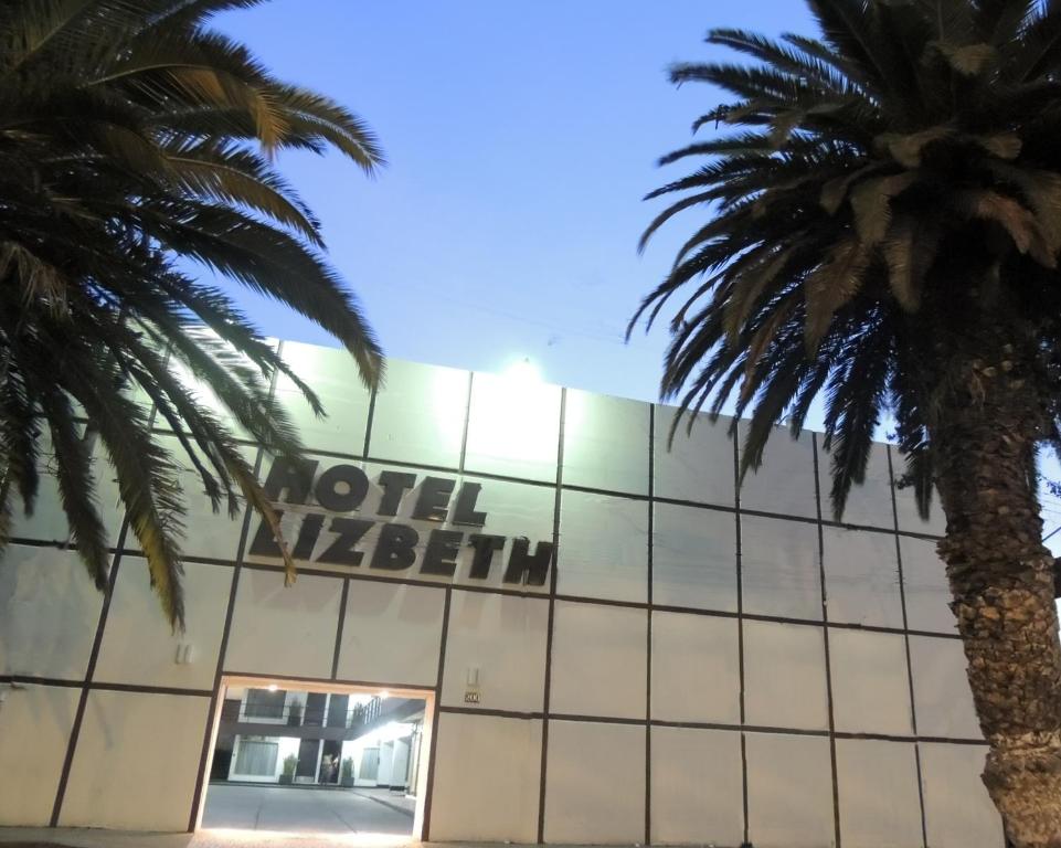 a hotel malibu with palm trees in front of it at Hotel Lizbeth in Tula de Allende