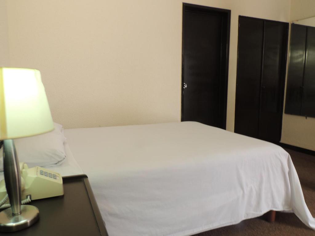 Postel nebo postele na pokoji v ubytování Hotel Lizbeth