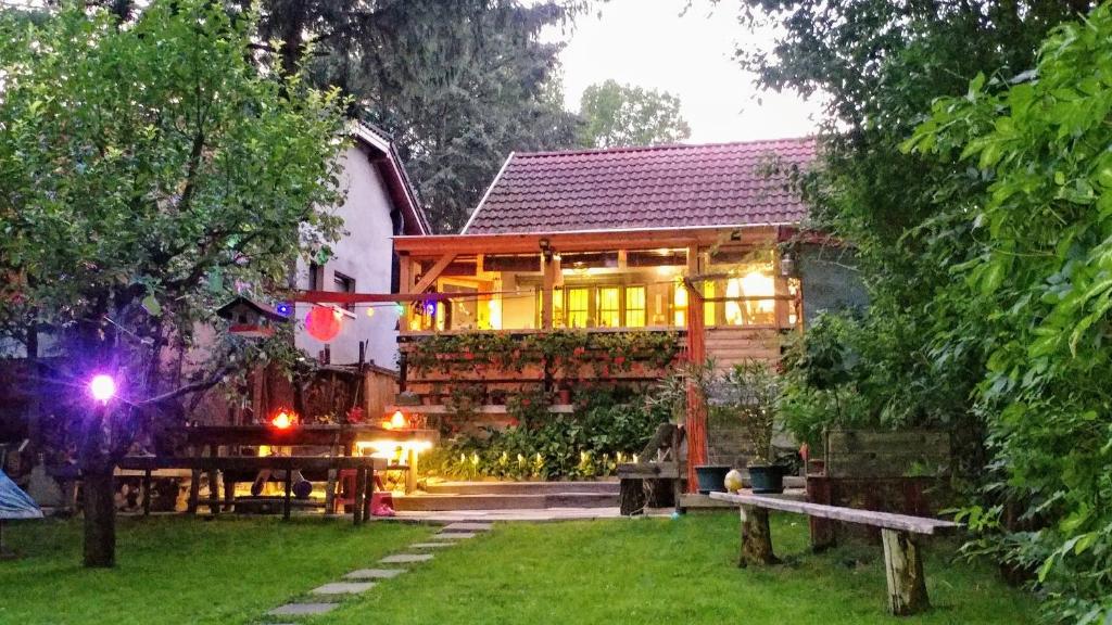 a wooden house with a table in the yard at Lovely vacation house at river Tisza , Hangulatos nyaraló a szegedi Tisza - Maros toroknál in Szeged