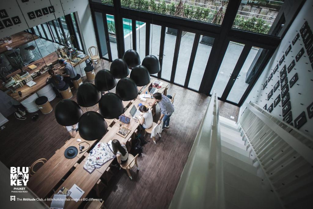 a group of people sitting at a table in a room at Blu Monkey Hub and Hotel Phuket Town- Free All Day Coworking space in Phuket Town