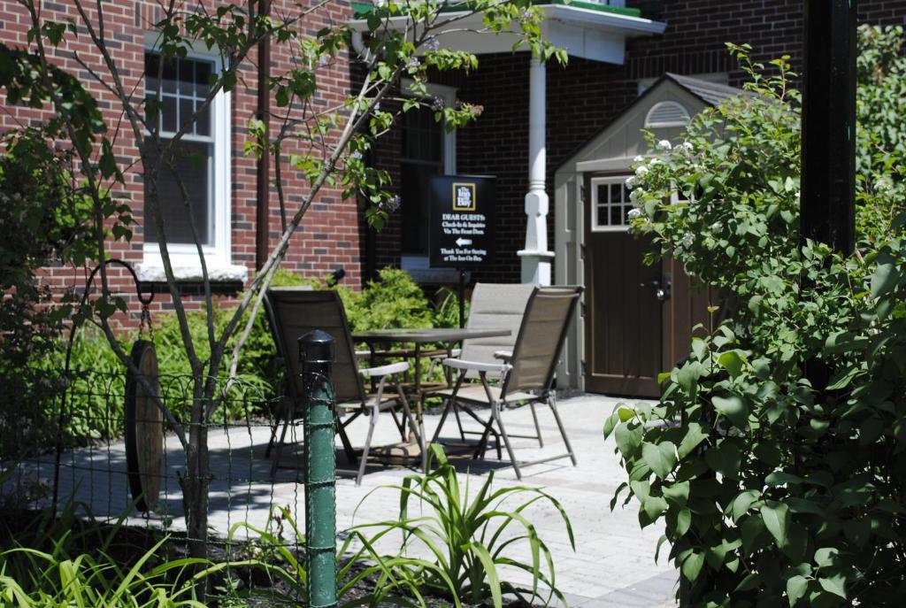 a patio with chairs and a table in front of a building at The Inn on Bay in Gravenhurst