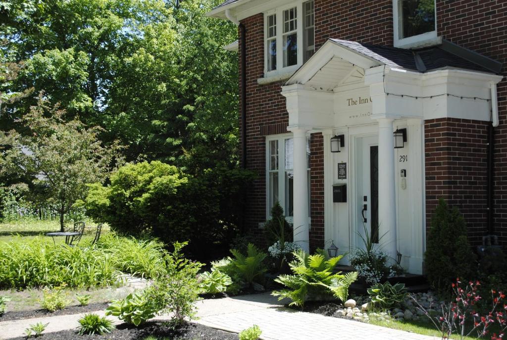 a brick house with a white front door at The Inn on Bay in Gravenhurst