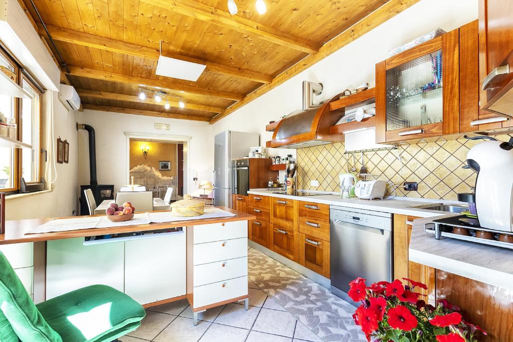 eine große Küche mit Holzdecken und Holzschränken in der Unterkunft La casa di Lo in Sorso