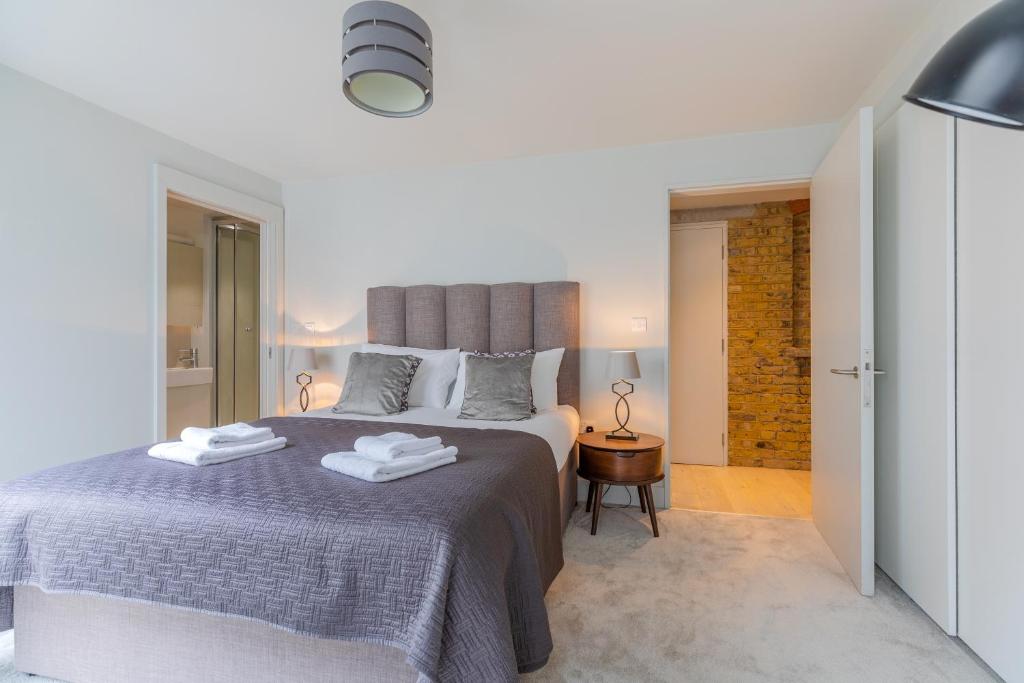a bedroom with a large bed with towels on it at StayInn Holborn in London