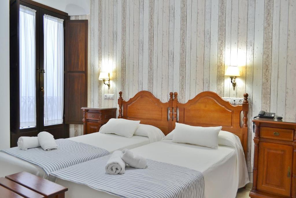 Postel nebo postele na pokoji v ubytování Hotel Marisa