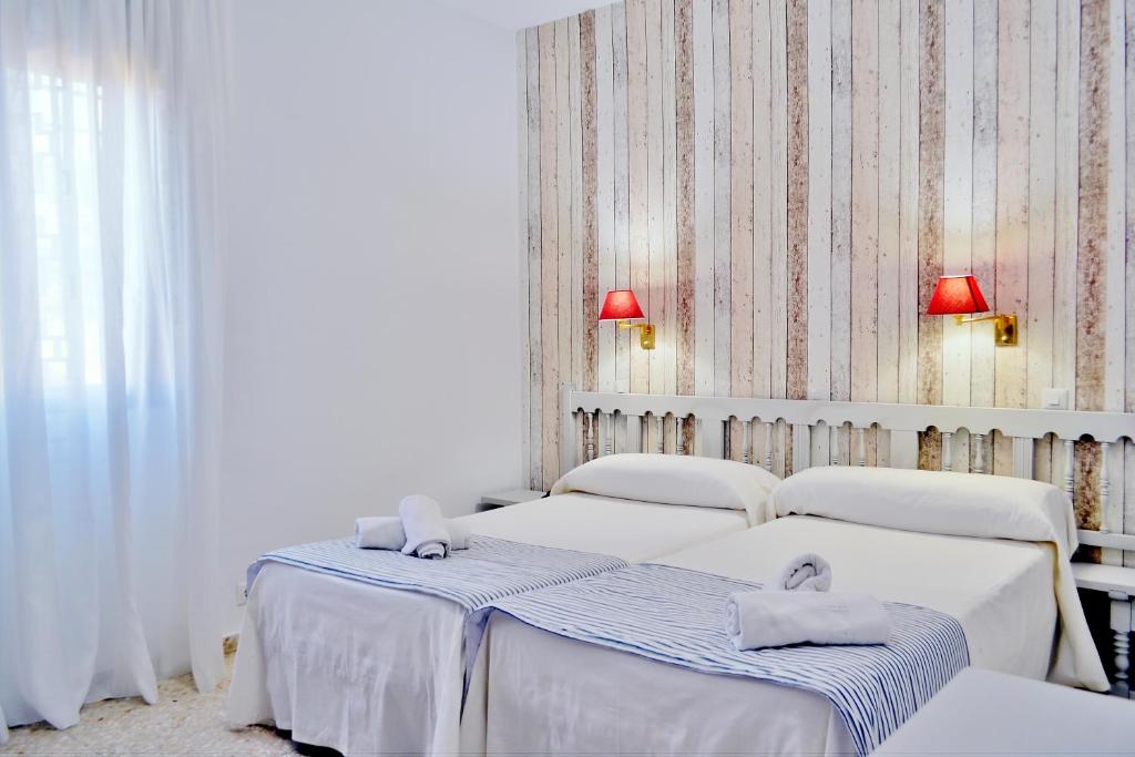 Postel nebo postele na pokoji v ubytování Hotel Marisa