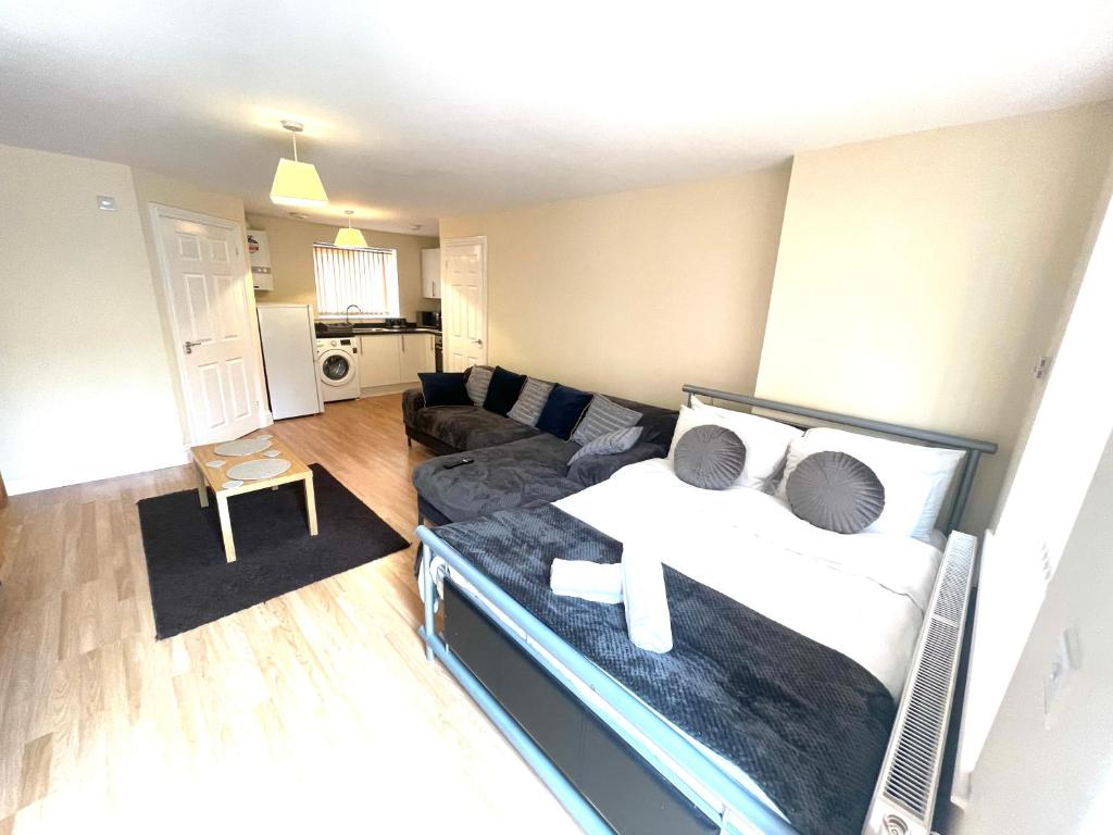 a living room with a bed and a couch at Lt Properties Studio apartment Ground floor 3 in Luton