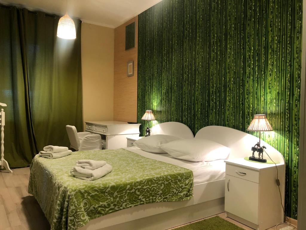 a hotel room with a bed and a green wall at Sverchkov 8 Hotel in Moscow