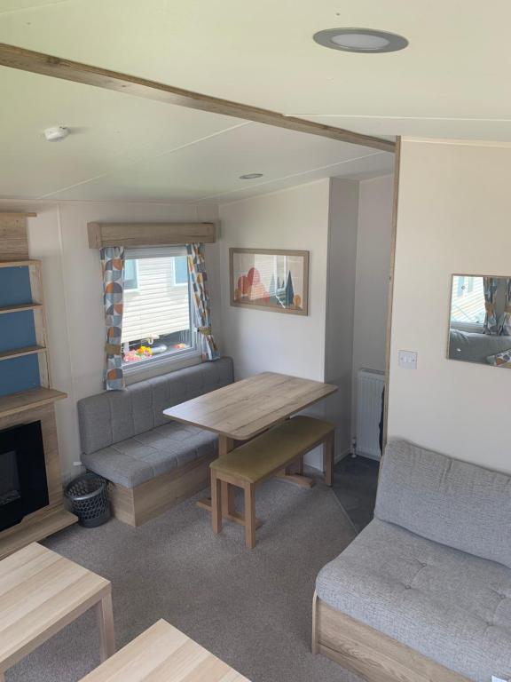 a living room with a couch and a table at Seton Sands Haven Holiday Village in Edinburgh