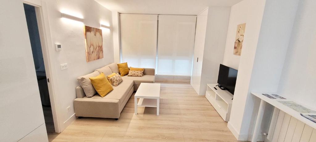 a living room with a couch and a table at Cozy White Home in Getxo in Getxo