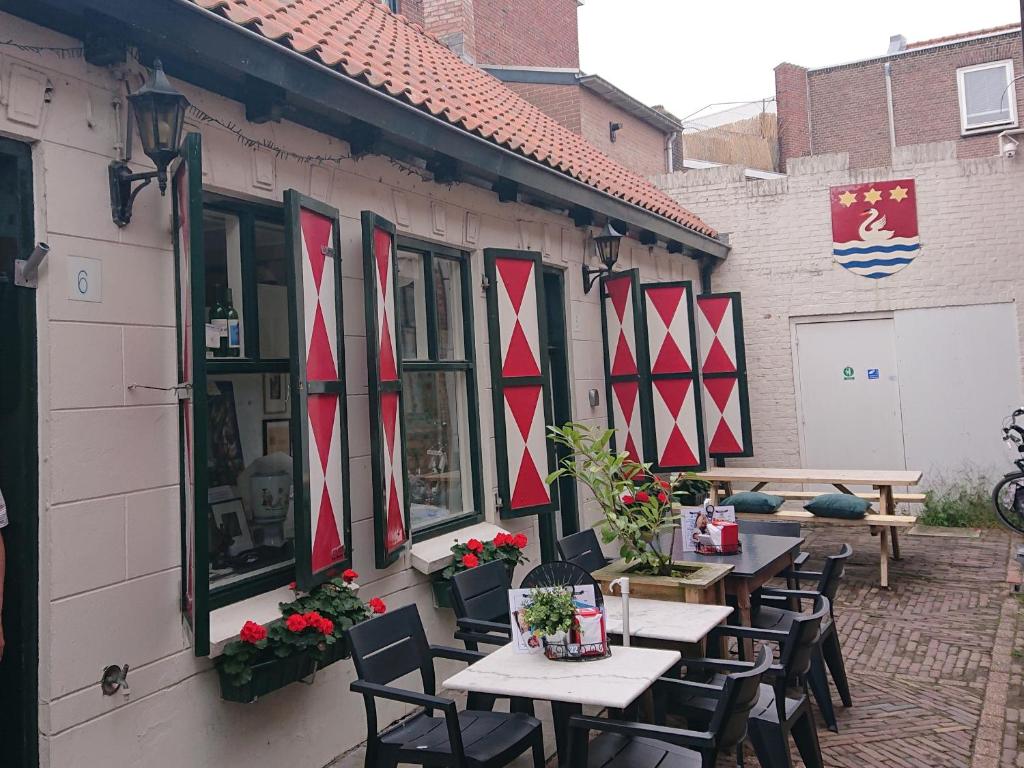 a row of tables and chairs outside of a building at Historisch Vissershuisje in Terneuzen