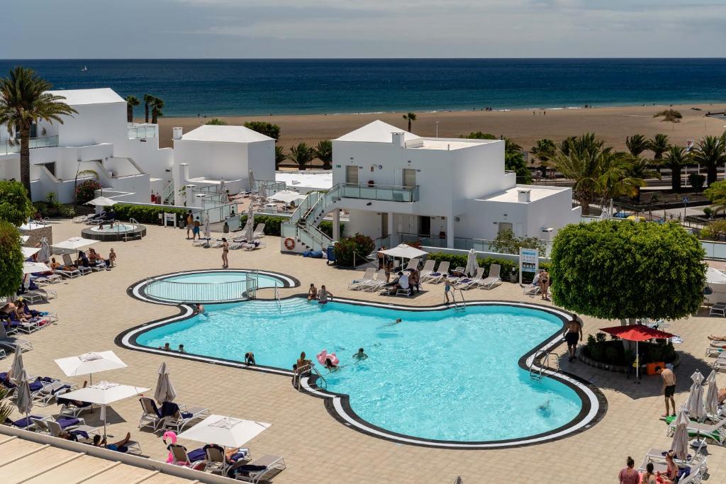 an overhead view of a swimming pool at a resort at Hotel Lanzarote Village in Puerto del Carmen