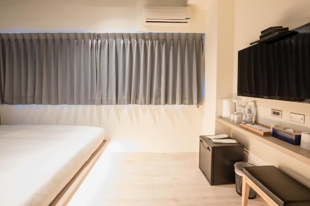 Postel nebo postele na pokoji v ubytování Traveller-Inn Day Moon Hotel