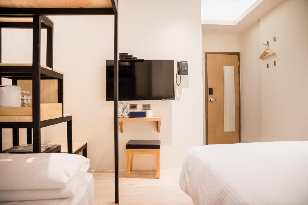 Postel nebo postele na pokoji v ubytování Traveller-Inn Day Moon Hotel