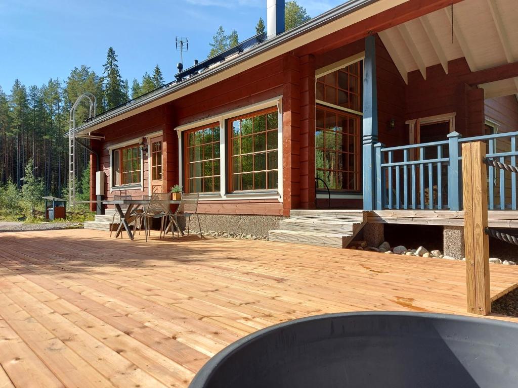 a house with a wooden deck in front of it at Aalto Koli in Kolinkylä