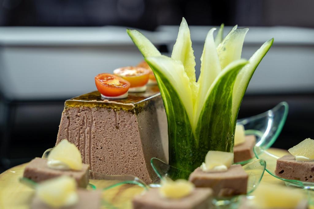 a vase with a plant on a table with desserts at Hotel Lanzarote Village in Puerto del Carmen