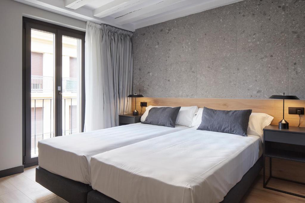 Postel nebo postele na pokoji v ubytování Hostal Espoz y Mina