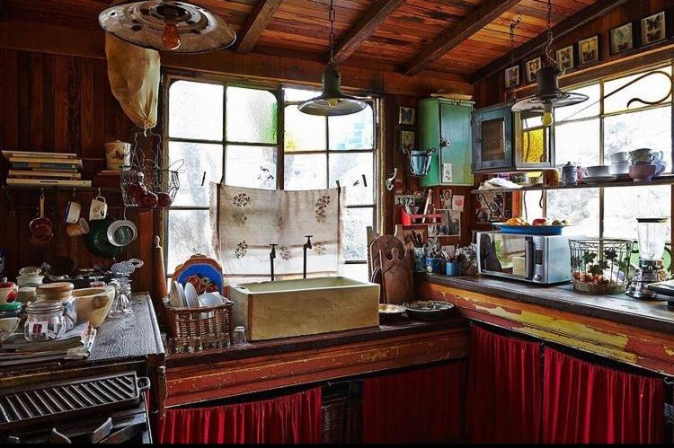 a kitchen with a counter with a sink and windows at La Verdosa in Tigre