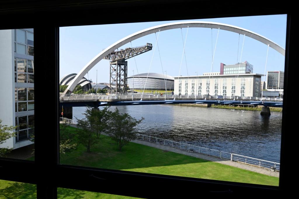 a view from a window of a bridge over a river at SEC/ Hydro Two Bed Flat With Free parking and Great View in Glasgow