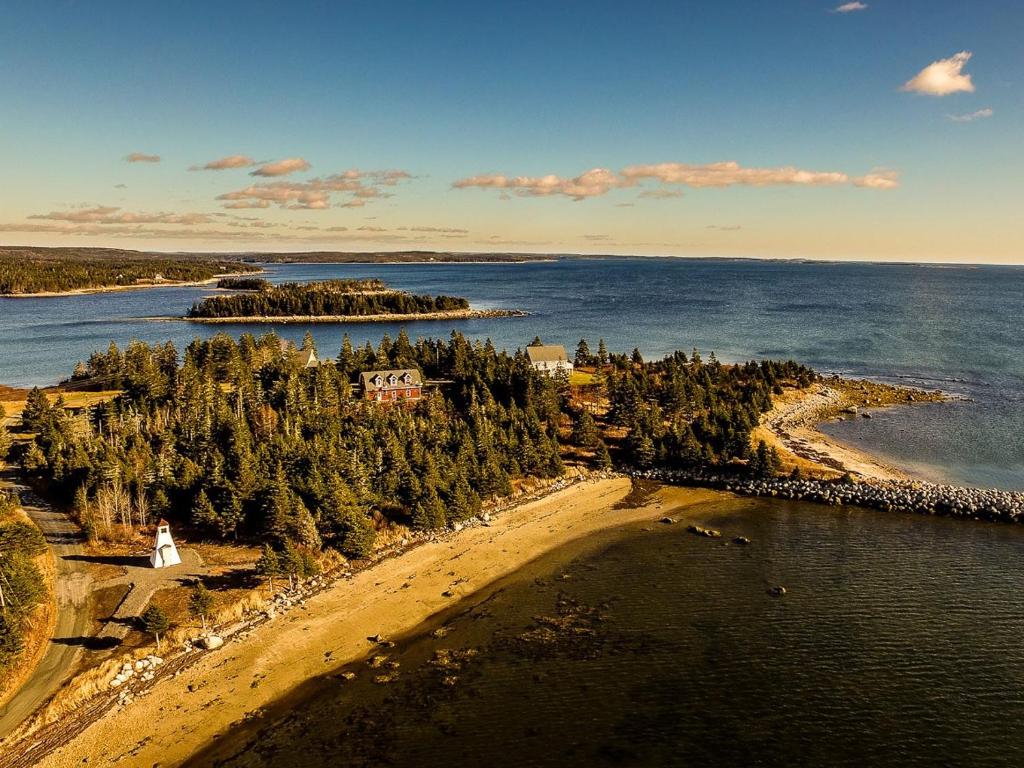 an aerial view of a beach with trees and water at Seawind Landing Country Inn in Larrys River