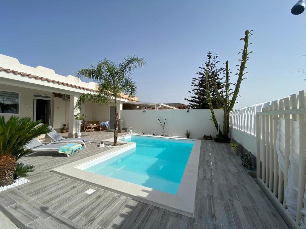 a swimming pool in the backyard of a house at Villa DiMari in Santa Maria Del Focallo