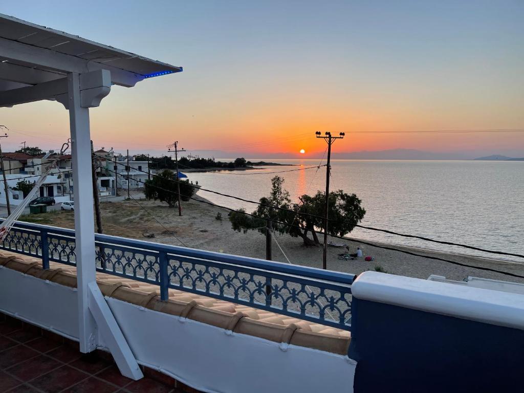 a view of the ocean from the balcony of a house at Coralli Rooms & Restaurant in Elafonisos