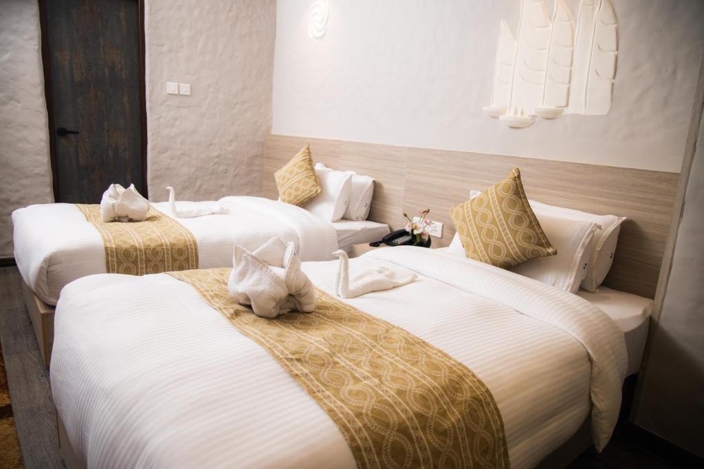 Postel nebo postele na pokoji v ubytování Vastu Boutique Hotel