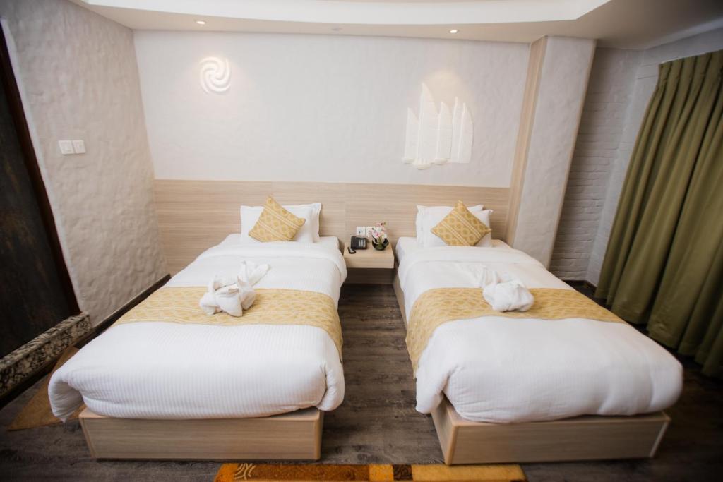 Postel nebo postele na pokoji v ubytování Vastu Boutique Hotel