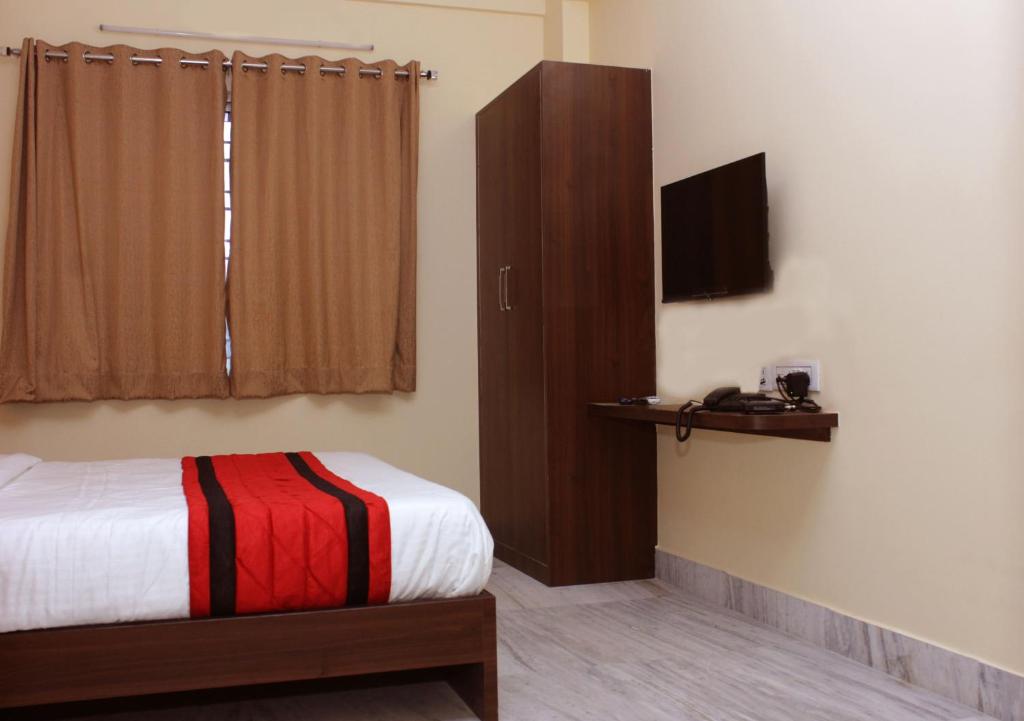 Postel nebo postele na pokoji v ubytování Sanjiva Suites
