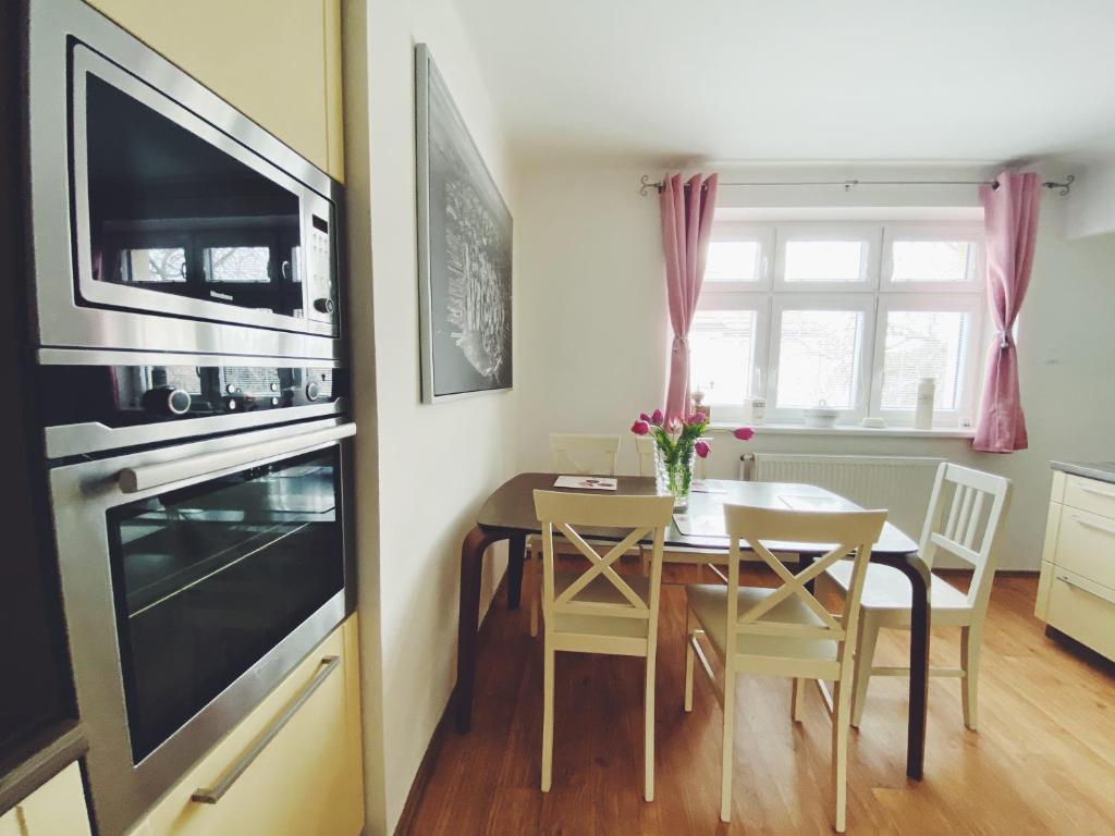a kitchen with a table and a dining room at Vila Lumír in Poděbrady