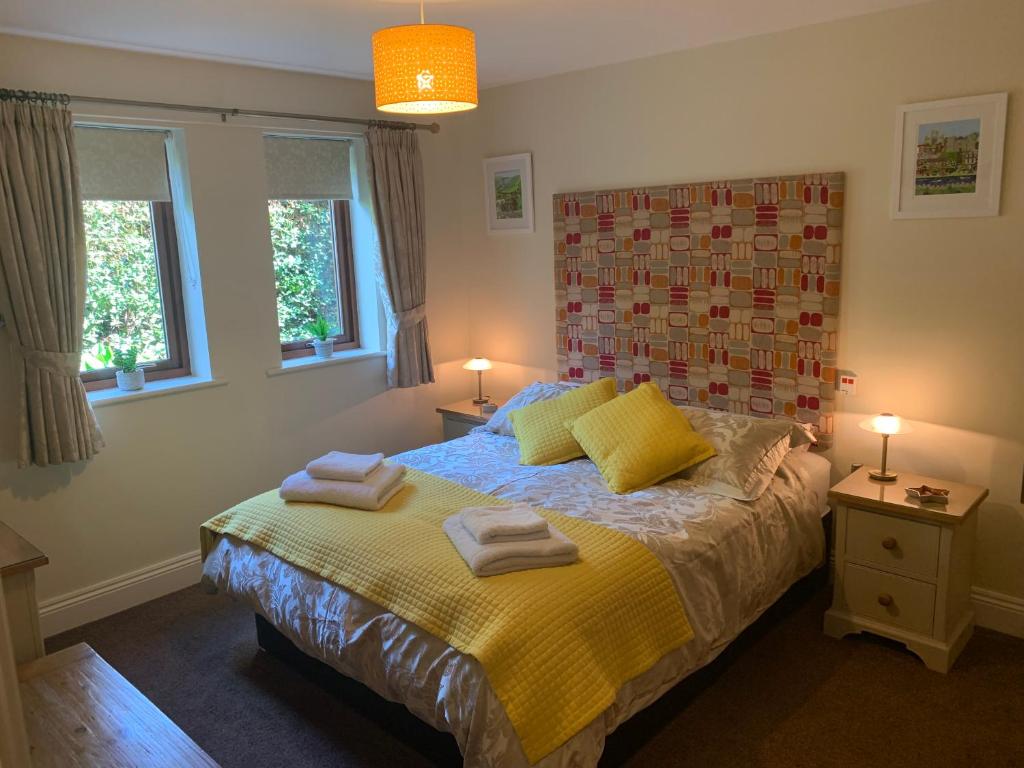 a bedroom with a bed with towels on it at Minster View Apartment at Talbot Court, York in York