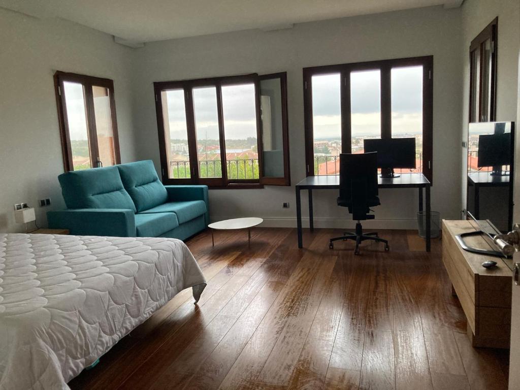 a bedroom with a bed and a couch and a desk at Sis Pobles Bed&Breakfast in La Senia