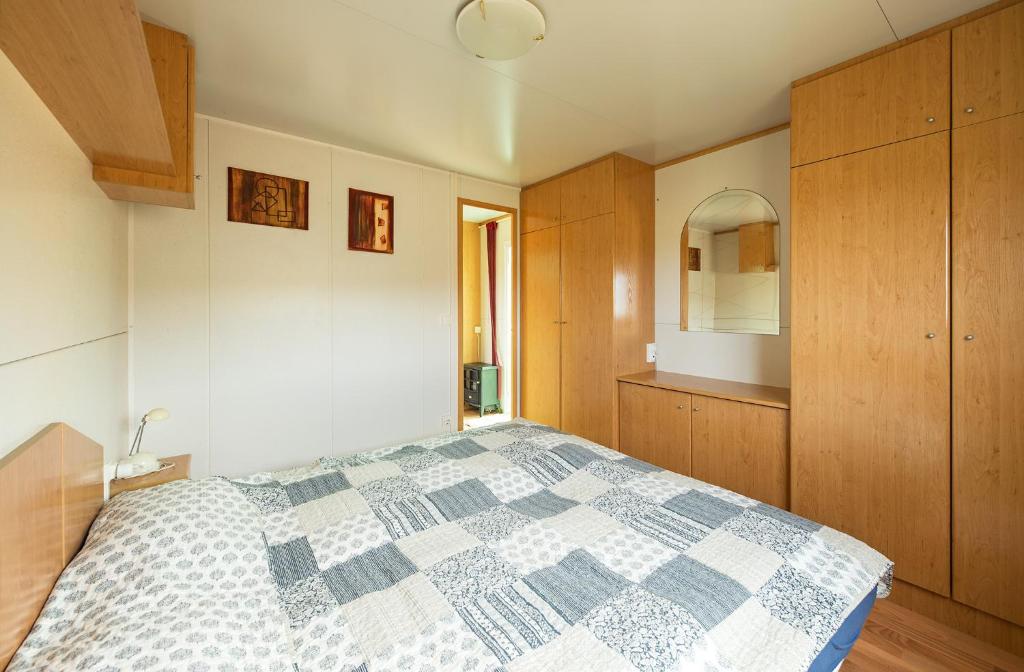 a bedroom with a bed with a blue and white quilt at Tenerife Paradise 11 Bungalow - Hotel Rural Fsj in San Juan de la Rambla