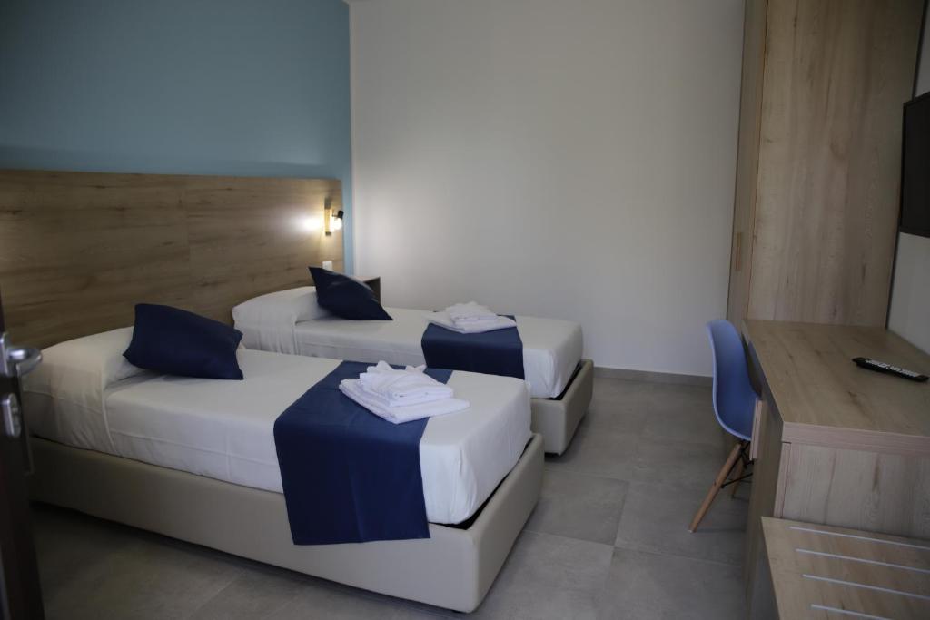 Posteľ alebo postele v izbe v ubytovaní Oasi Guzzetta Hotel&Case Vacanze