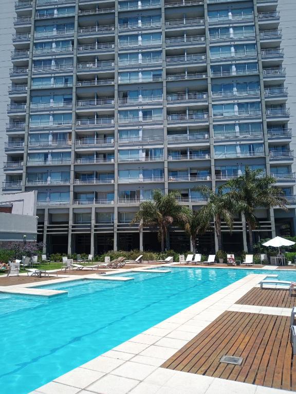 a large apartment building with a large swimming pool at Quartier San Telmo Luxury Pool Gym & Spa, piscina climatizada in Buenos Aires