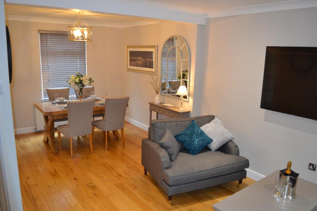 a living room with a table and a chair at Sea Haven in Conwy