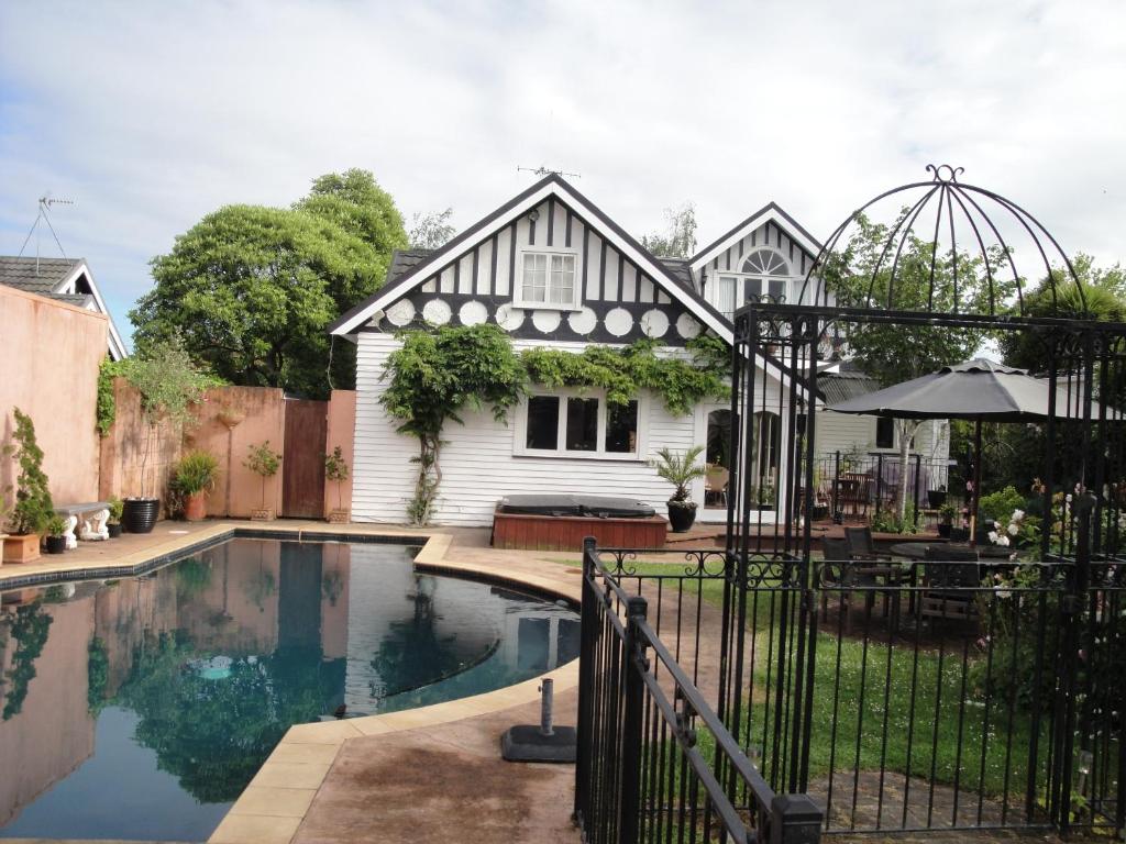 a house with a swimming pool in the yard at English Tudor House in Hamilton